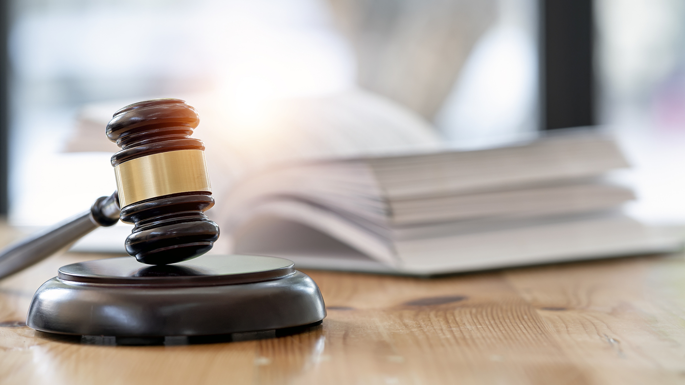 Wooden brown judge gavel on the table, copy space, banner background.